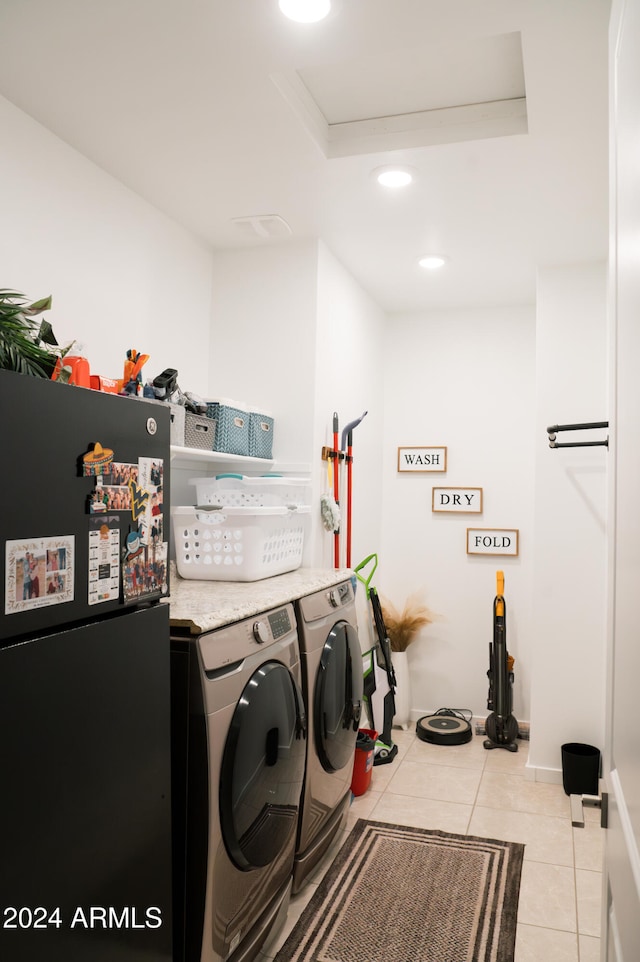 laundry room with separate washer and dryer and light tile patterned flooring