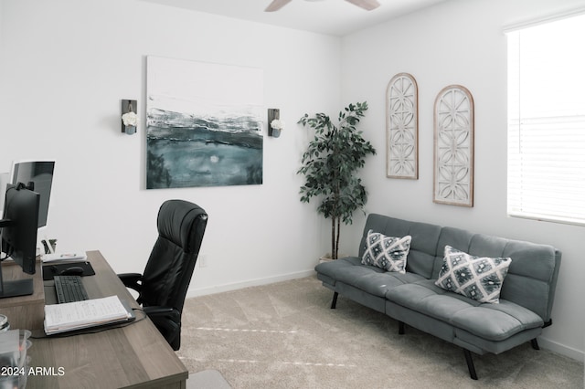 office area featuring light carpet and ceiling fan