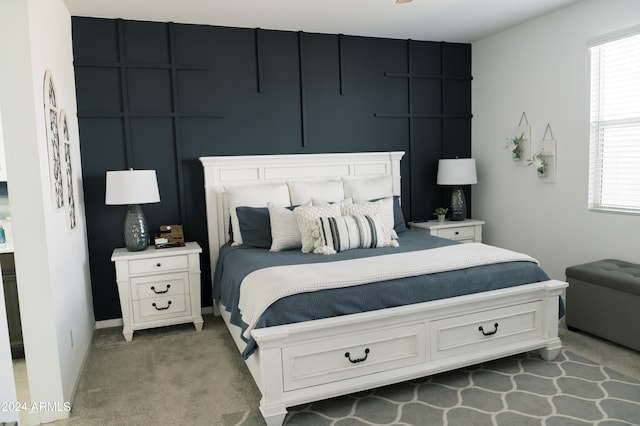 carpeted bedroom featuring multiple windows