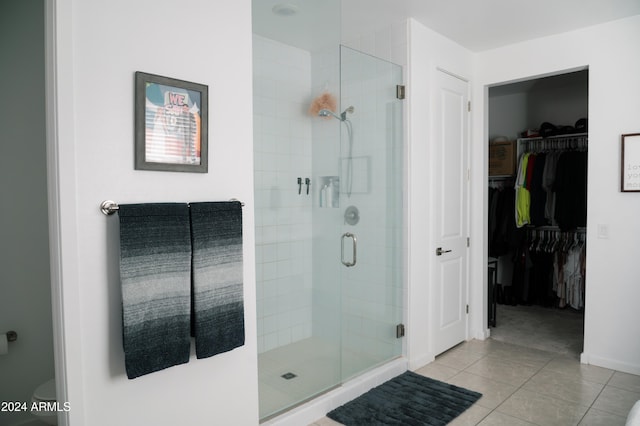 bathroom featuring tile patterned flooring and a shower with door