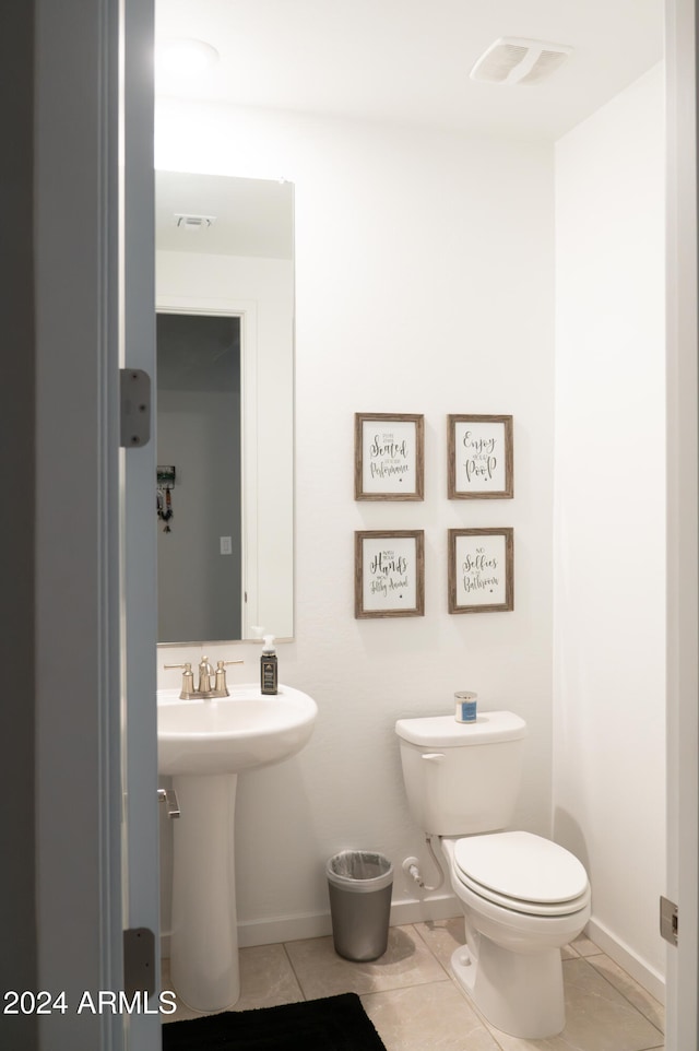 bathroom featuring tile patterned flooring and toilet