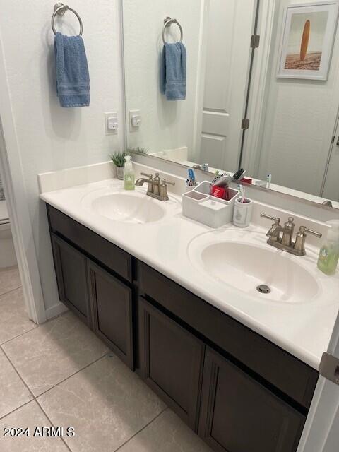 bathroom featuring tile patterned floors, vanity, and toilet