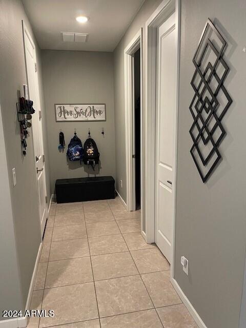 corridor featuring light tile patterned floors