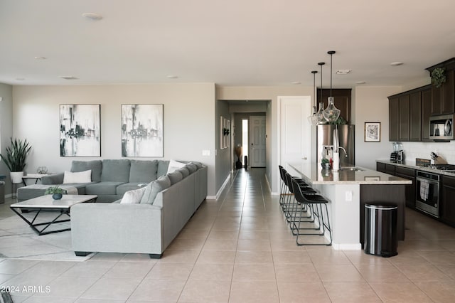 living room with light tile patterned floors and sink