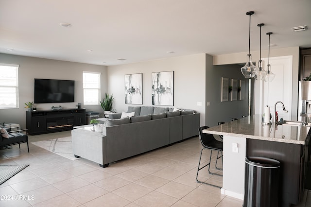 living room with light tile patterned floors and sink