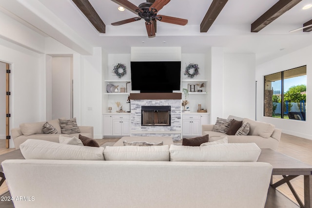 living room with beamed ceiling, ceiling fan, and light hardwood / wood-style flooring