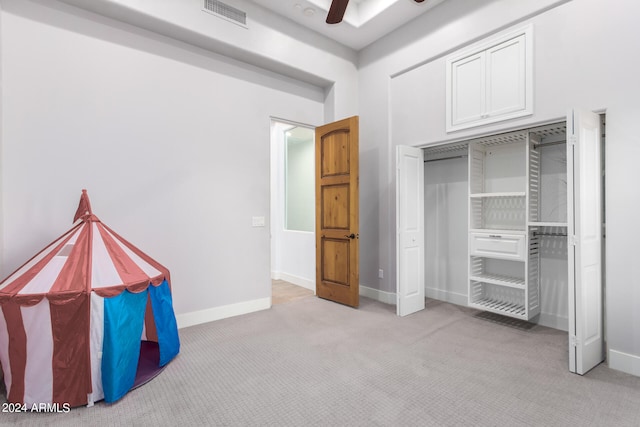 unfurnished bedroom featuring ceiling fan and light colored carpet