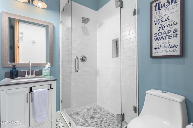 bathroom featuring walk in shower, vanity, and toilet