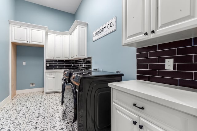 washroom featuring cabinets and separate washer and dryer