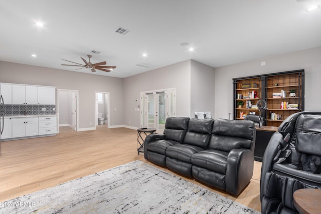 living room with ceiling fan and light wood-type flooring