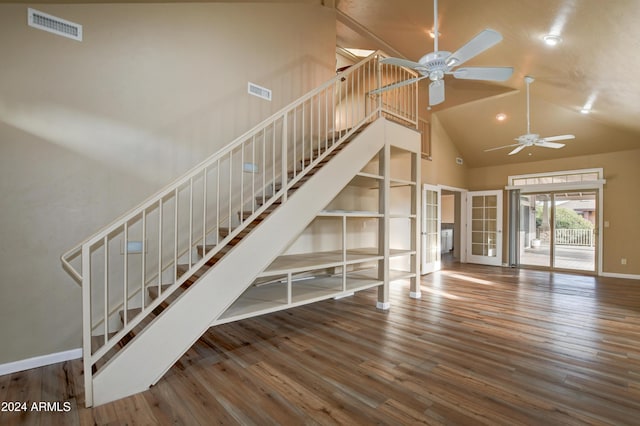 unfurnished living room featuring wood-type flooring, high vaulted ceiling, and ceiling fan