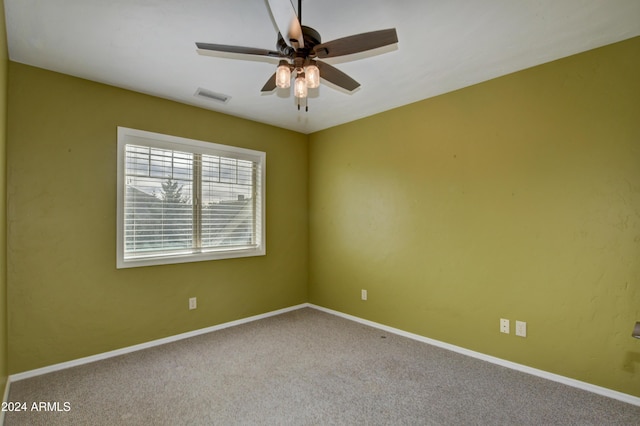 empty room with ceiling fan and carpet floors