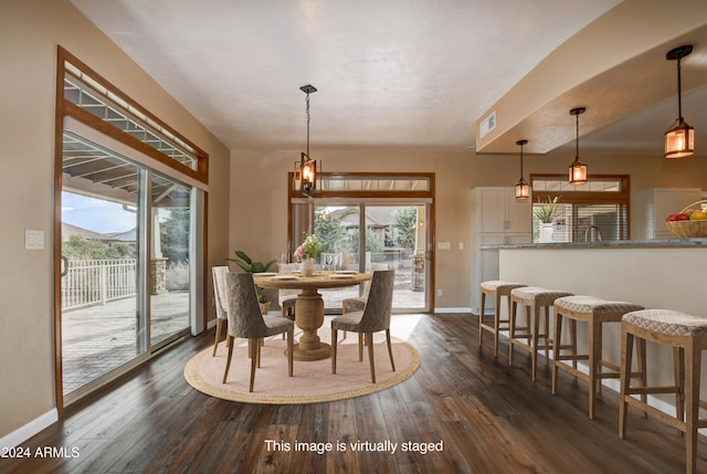 dining room featuring plenty of natural light and dark hardwood / wood-style flooring