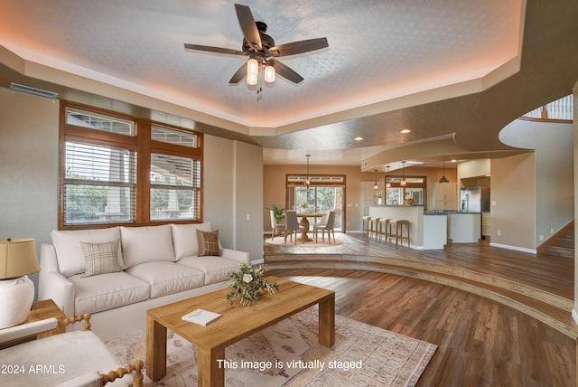 unfurnished living room featuring hardwood / wood-style floors, a textured ceiling, and ceiling fan