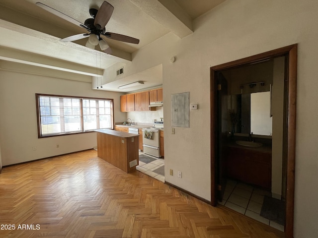 kitchen with white range with electric stovetop, visible vents, a kitchen island, light countertops, and beam ceiling