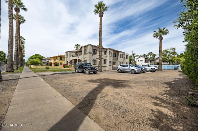 uncovered parking lot with a residential view