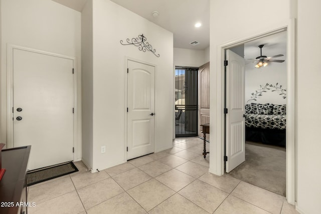 hall featuring light tile patterned floors