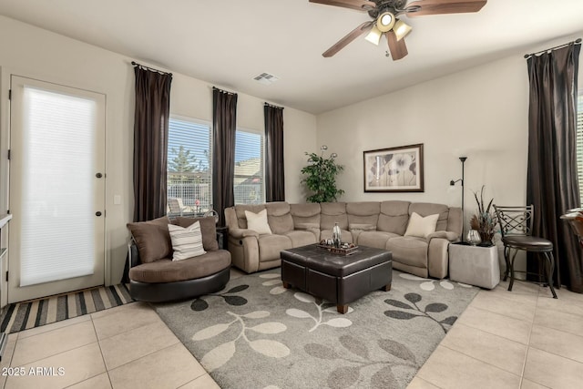 tiled living room with ceiling fan