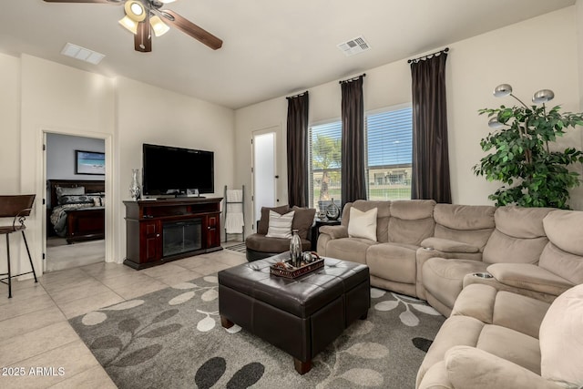 living room featuring ceiling fan and light tile patterned floors