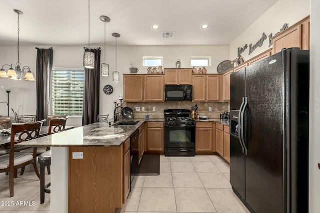 kitchen featuring sink, a notable chandelier, black appliances, and hanging light fixtures