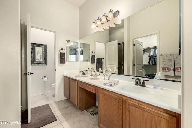 bathroom featuring vanity, tile patterned flooring, and toilet