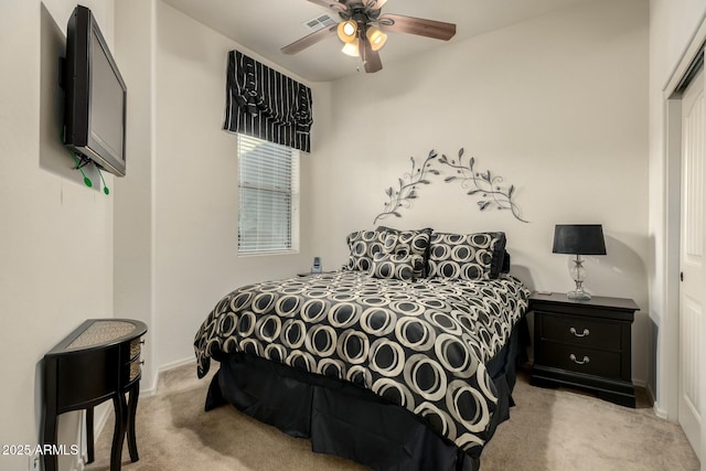 bedroom featuring ceiling fan, a closet, and light carpet