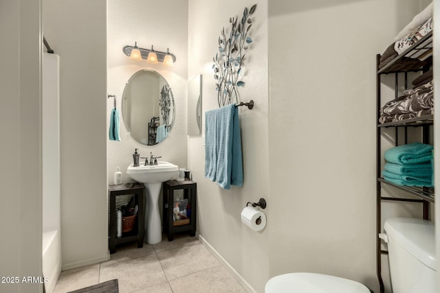 bathroom featuring toilet and tile patterned floors