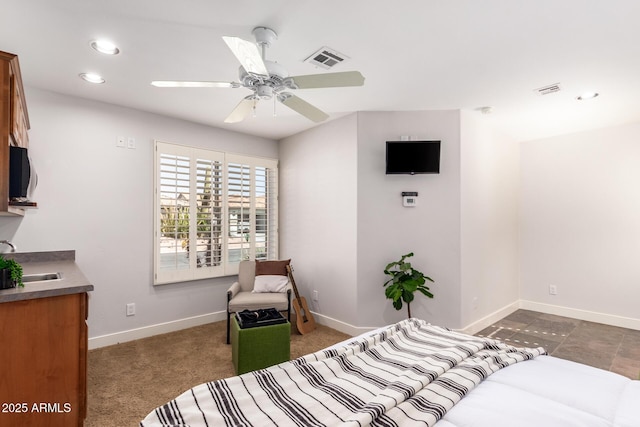 carpeted bedroom with baseboards, visible vents, ceiling fan, a sink, and recessed lighting