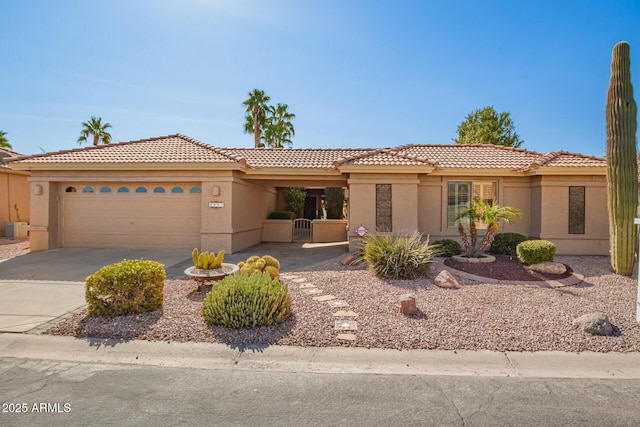 view of front of house featuring an attached garage, concrete driveway, and stucco siding