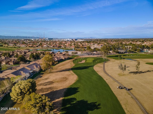 drone / aerial view with view of golf course and a residential view