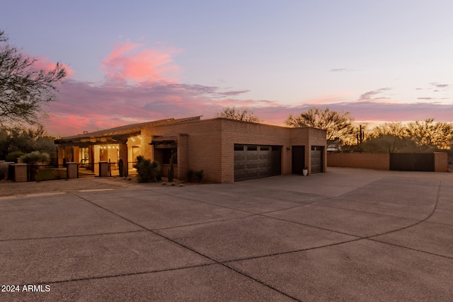 pueblo-style house featuring a garage