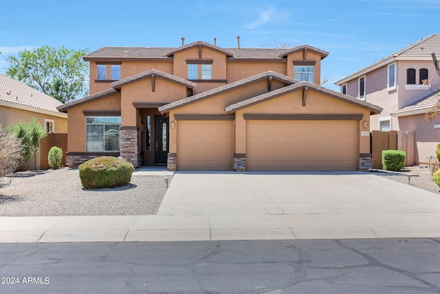 view of front of house featuring a garage, stone siding, and stucco siding