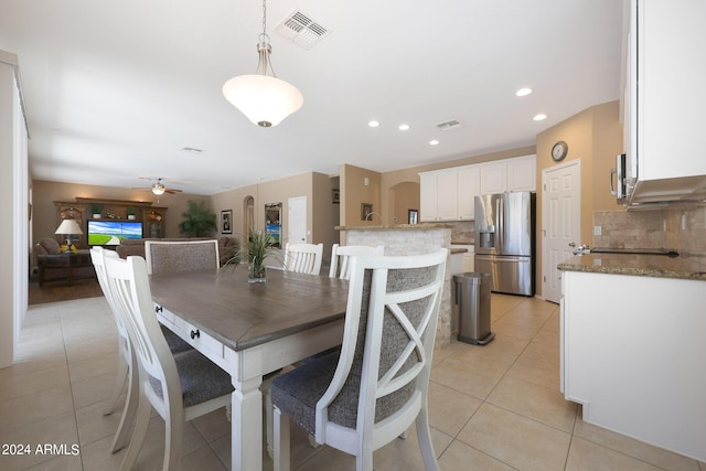 dining space featuring light tile patterned floors, arched walkways, recessed lighting, visible vents, and a ceiling fan