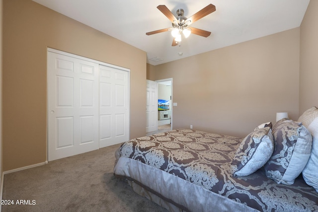 bedroom with a closet, carpet flooring, visible vents, and a ceiling fan