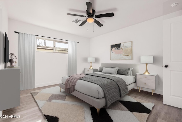 bedroom with ceiling fan and light wood-type flooring