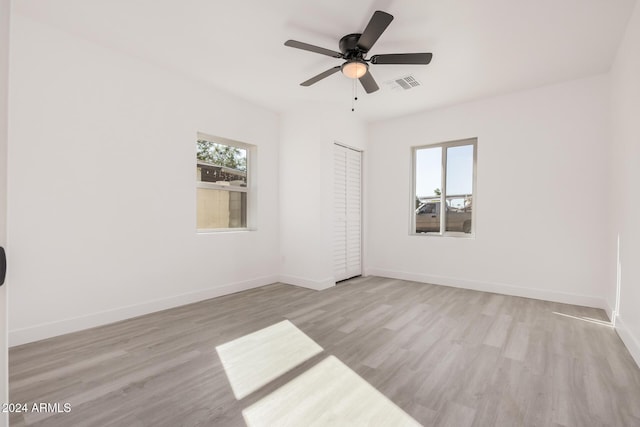 unfurnished room featuring ceiling fan and light wood-type flooring