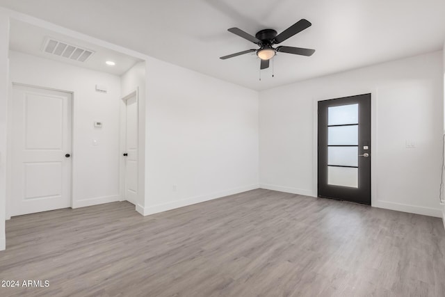 spare room with ceiling fan and light hardwood / wood-style floors