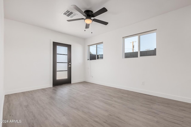 empty room with hardwood / wood-style flooring and ceiling fan