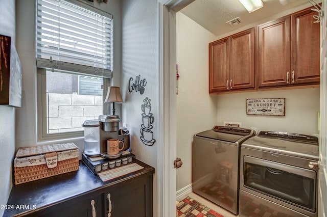 laundry room featuring visible vents, cabinet space, and washer and dryer