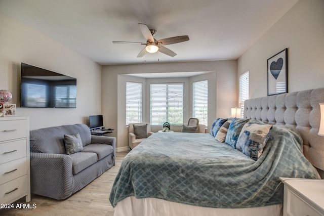 bedroom with a ceiling fan and light wood-style floors