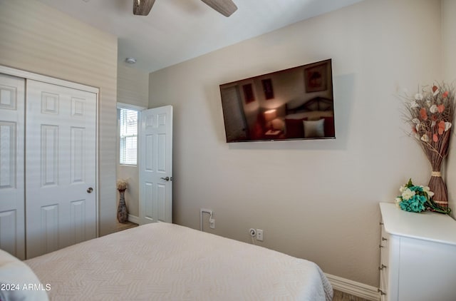 bedroom with a closet, ceiling fan, and baseboards