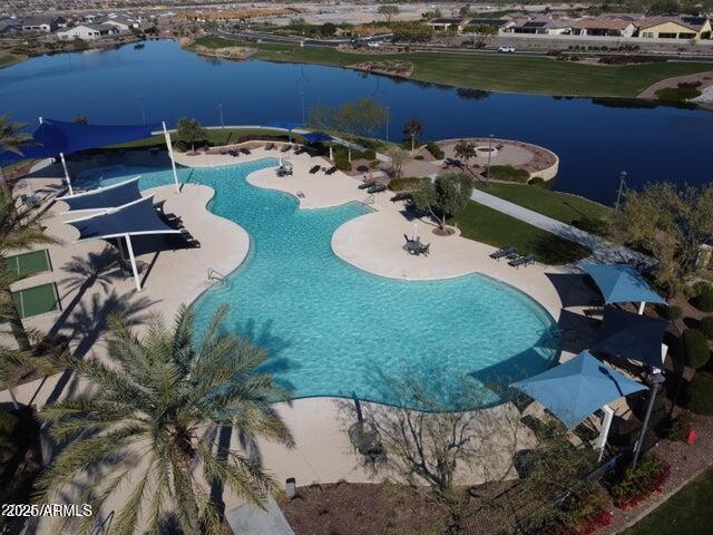 view of pool featuring a patio area and a water view