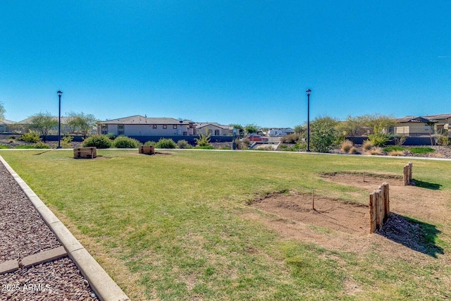 view of property's community featuring a residential view and a yard