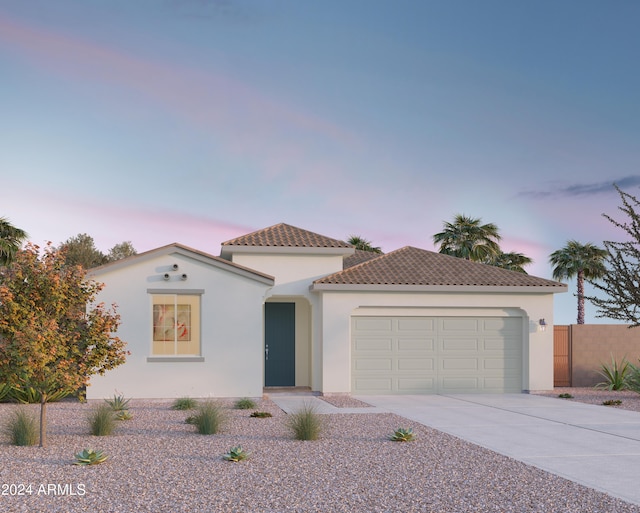 mediterranean / spanish-style house with a garage