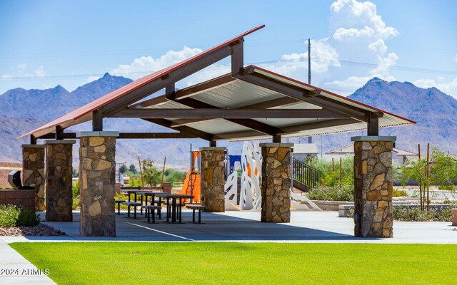 surrounding community with a lawn, a mountain view, and a gazebo