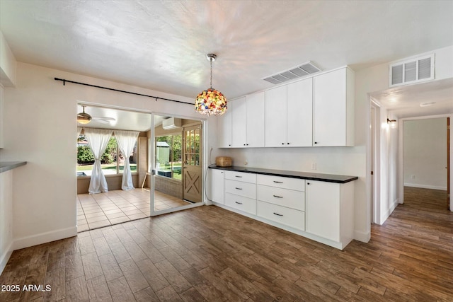 7813 N 17th Dr, Phoenix, AZ 85021 - kitchen featuring dark countertops, dark wood-type flooring, and visible vents