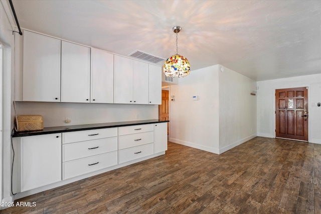 7813 N 17th Dr, Phoenix, AZ 85021 - kitchen featuring dark wood-style floors, visible vents, dark countertops, and white cabinetry