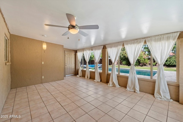 7813 N 17th Dr, Phoenix, AZ 85021 - interior space with light tile patterned floors, a textured wall, and ceiling fan