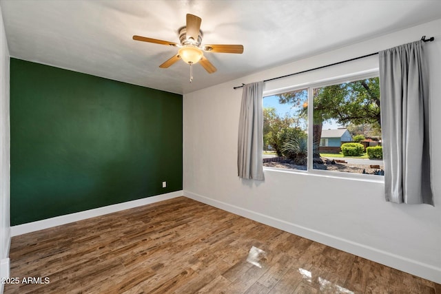 7813 N 17th Dr, Phoenix, AZ 85021 - empty room featuring wood finished floors, a ceiling fan, and baseboards