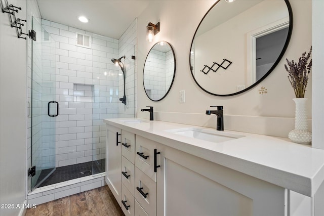 7813 N 17th Dr, Phoenix, AZ 85021 - bathroom with double vanity, wood finished floors, a stall shower, and a sink